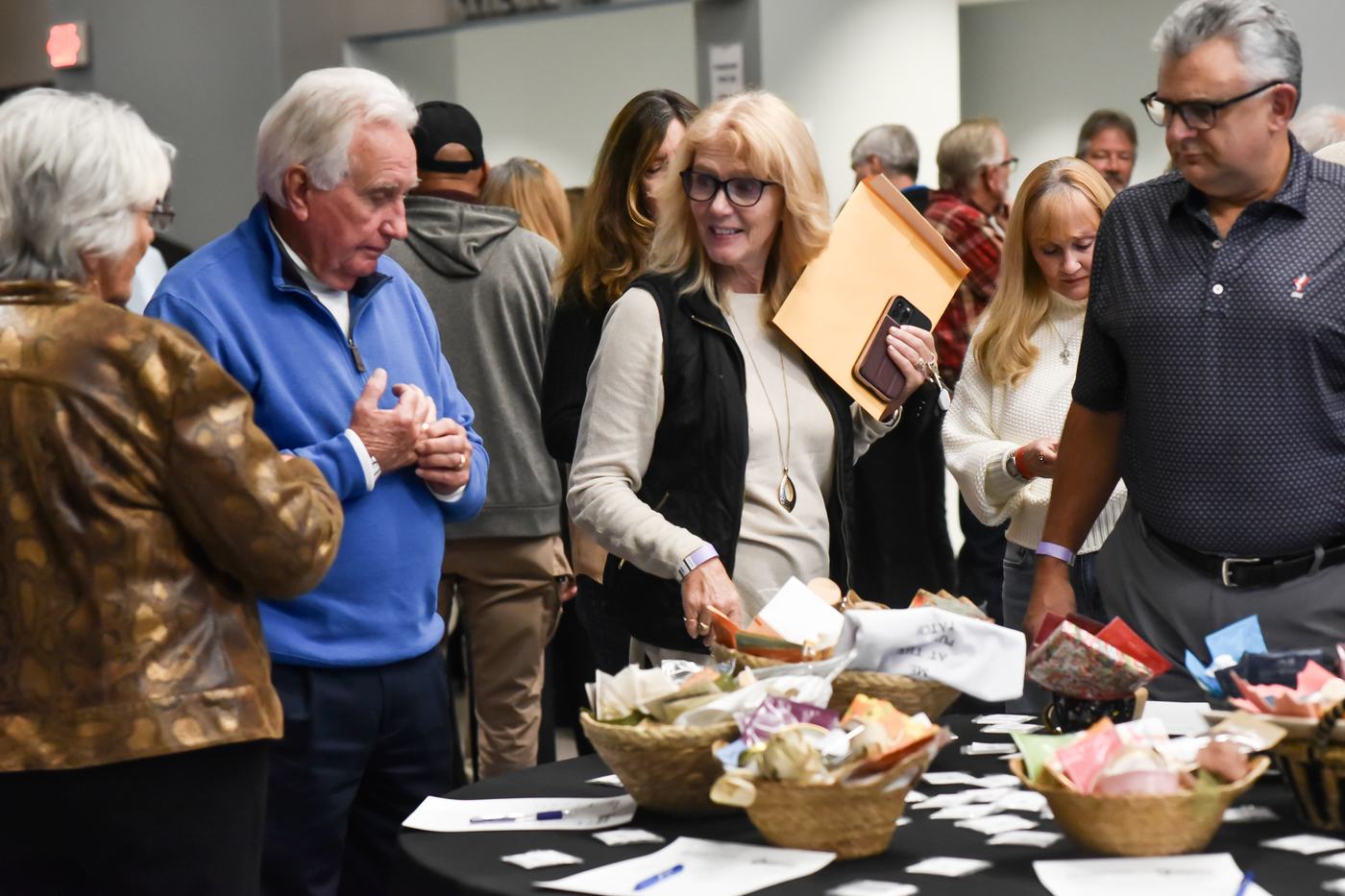 Guests browsing silent auction baskets at last year's show